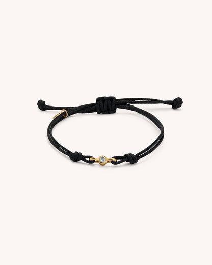 EIEN bracelet with double black cord and central lab-grown diamond set in gold vermeil, product photo on neutral background.